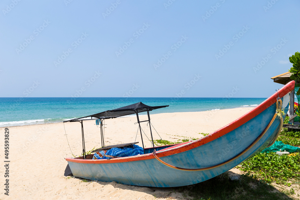 Fishing boat on tropical beach, summer outdoor day light
