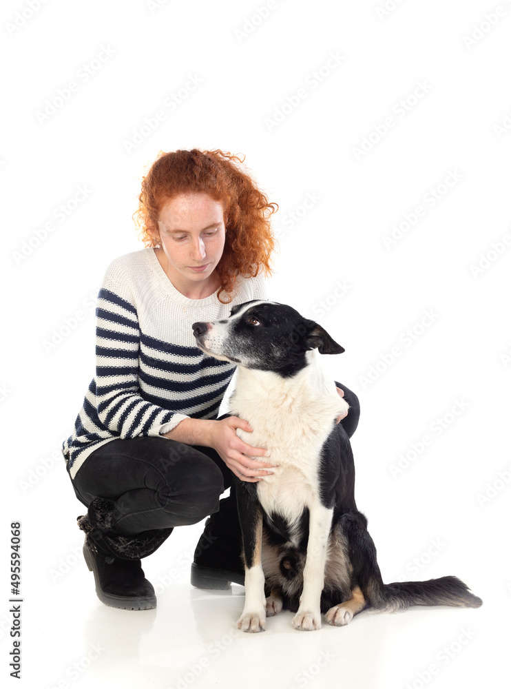 Red-haired girl with a white and black dog Red-haired girl with a white and black dog