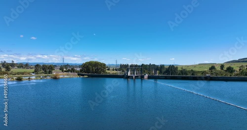 Flight over hydro electric lake surface towards outflow gates - New Zealand photo