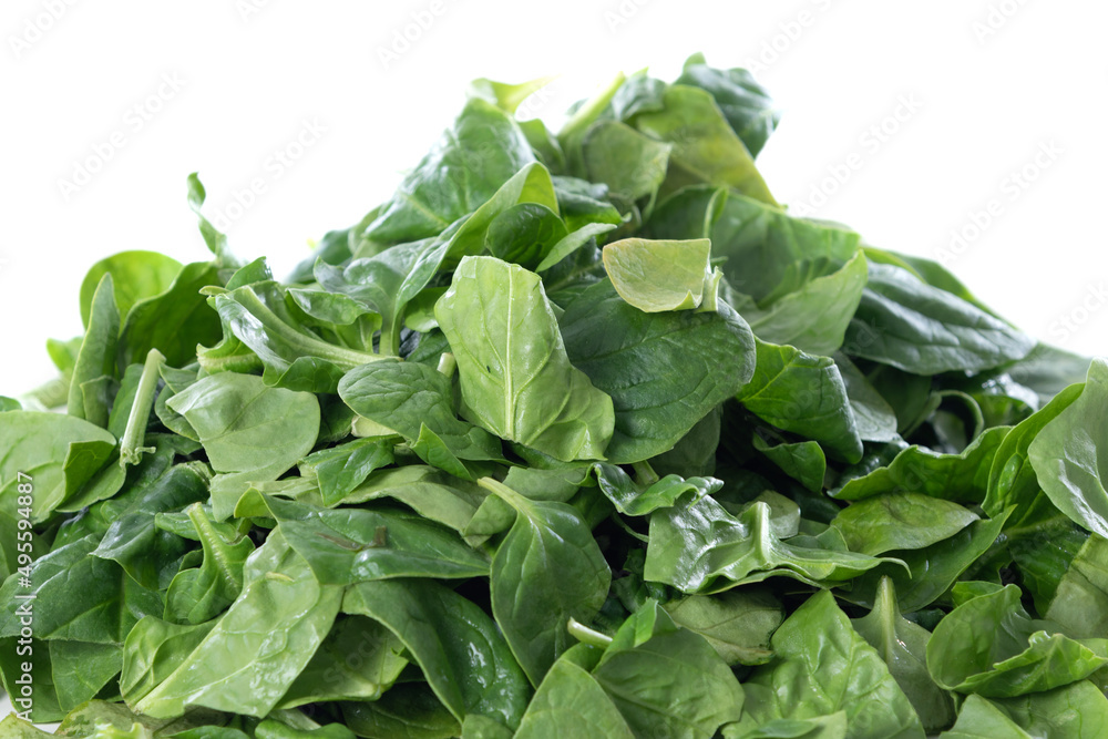 Pile of fresh green baby spinach leaves isolated on white background Pile of fresh green baby spinach leaves isolated on white background