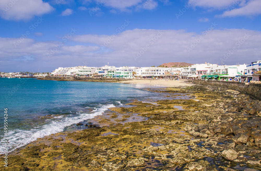 A view of the Playa Blanca beach area at low tide in Playa Blanca, Lanzarote. 