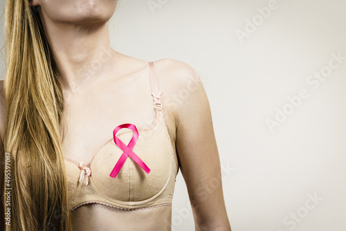 Woman chest in bra, pink cancer ribbon © Voyagerix