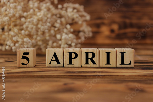 Calendar for April 5: cubes with the number 5, the name of the month of April in English. April holidays and significant dates.