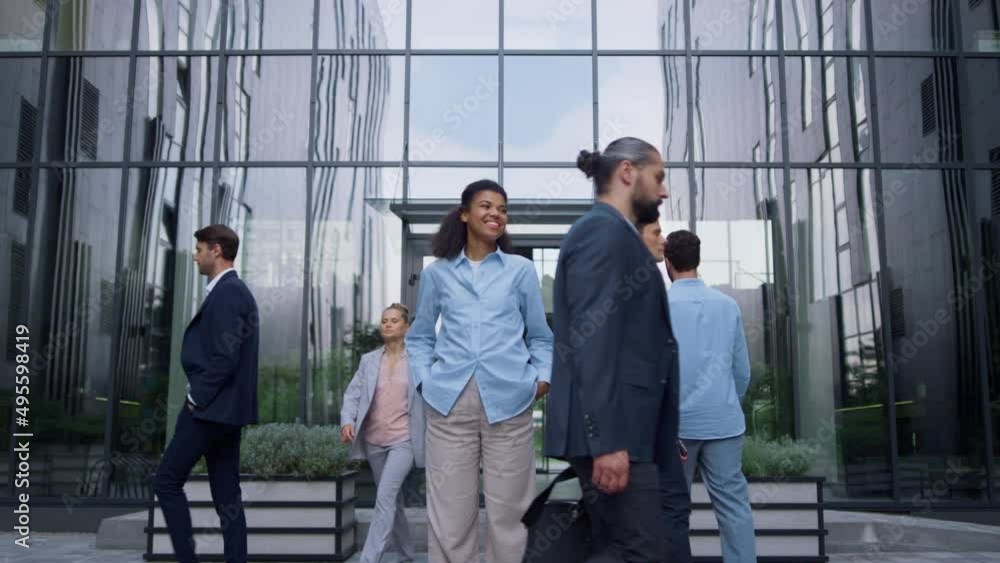 Smiling business lady standing feeling confident outdoors modern glass building. Smiling business lady standing feeling confident outdoors modern glass building.