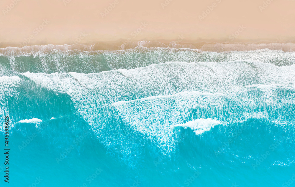 Aerial top view of Beautiful sunny sea beach with amazing azure blue wave water background