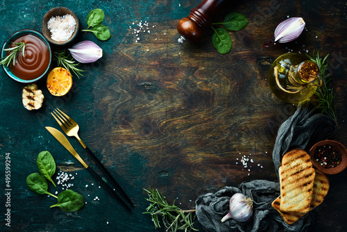 Cooking background. Vegetables, spices and kitchen utensils on a stone background. Top view.