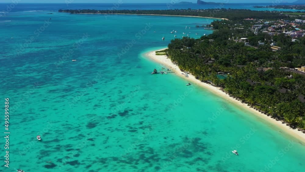 Tropical beach in Mauritius. Sandy beach with palms and blue transparent ocean. Aerial view Tropical beach in Mauritius. Sandy beach with palms and blue transparent ocean. Aerial view