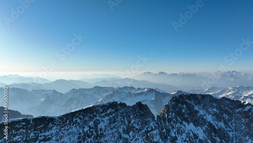 Person standing on a narrow mountain ridge in winter. Monte Collalto, Vedrette di Ries, Alpi Pusteresi. photo