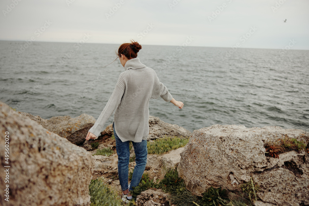 pretty woman sweaters cloudy sea admiring nature Lifestyle back view