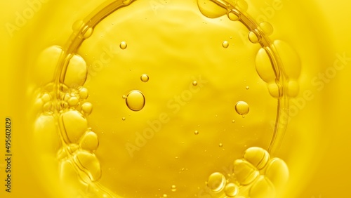 Top view macro shot of violed liquid in beaker with bubbles on yellow background | Abstract face care cosmetics formulation concept