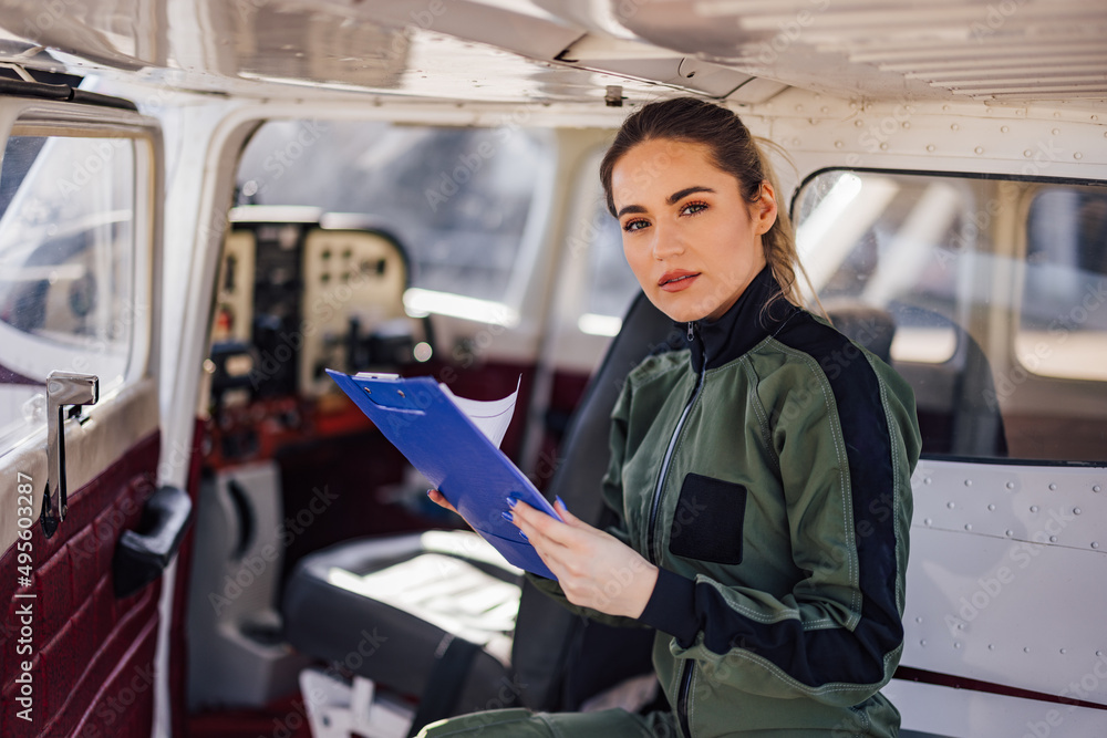 Portrait of confident Caucasian woman, an aviator in uniform.