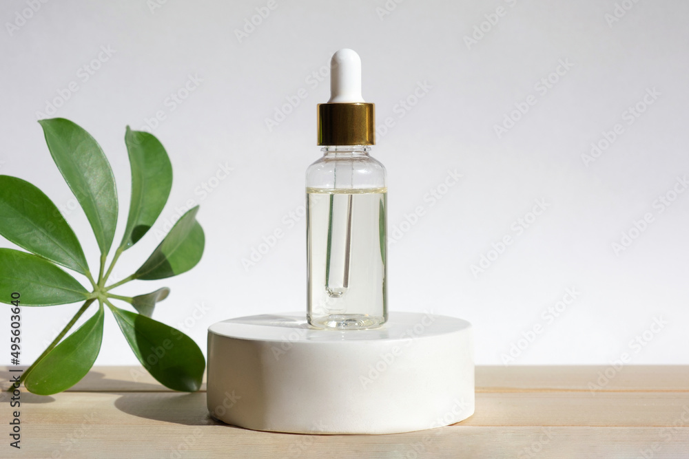 Natural oil cosmetics. Dropper glass Bottle Mock-Up. Oily cosmetic pipette. Face and body treatment. Spa concept. Mineral organic liquid. Front view. Beauty products. Blank packaging on pedestal