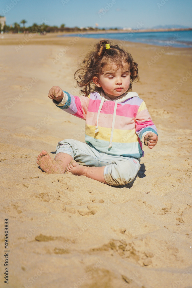 Little girl having meditation time at the beach Little girl having meditation time at the beach