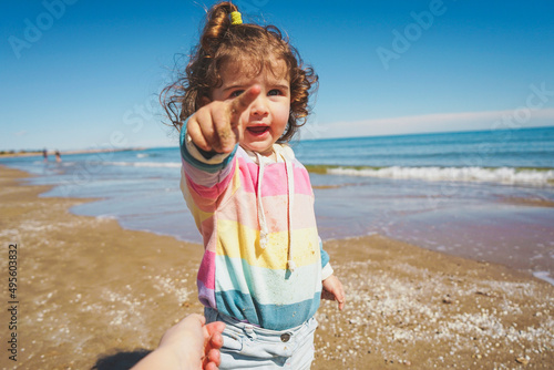 Mid section of a little girl playing at the seashore