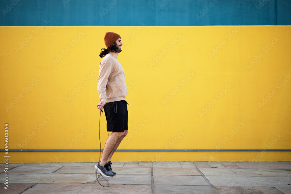 Young muscle man training outside. Fit handsome man doing exercise Young muscle man training outside. Fit handsome man doing exercise