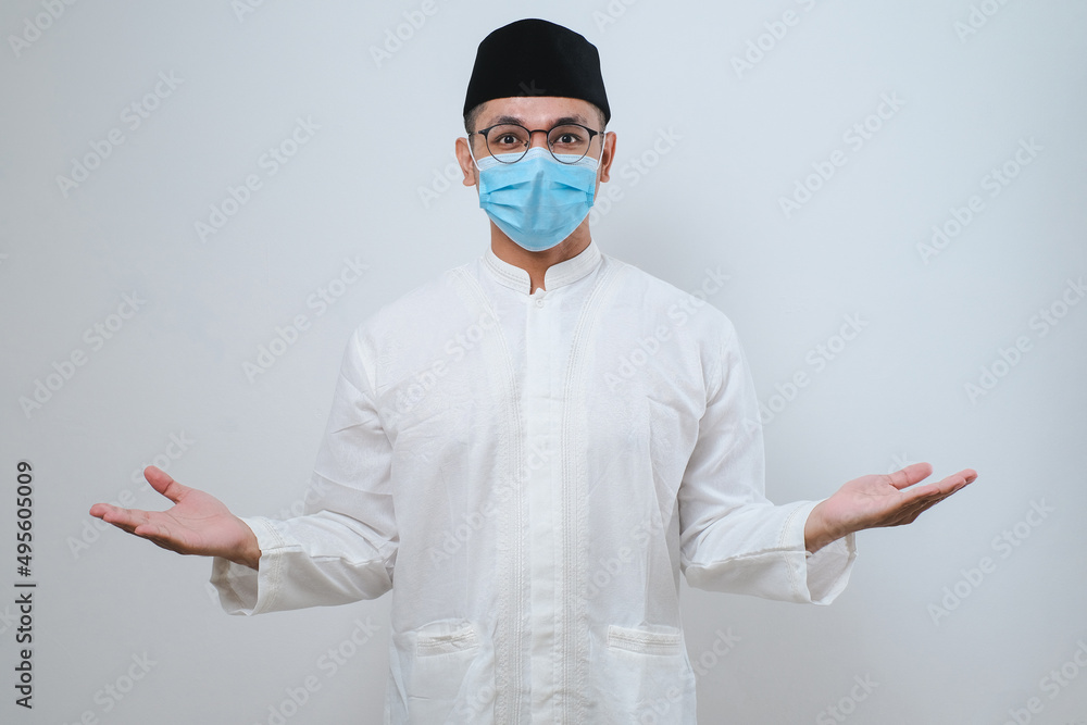 Asian man smiling happy to greeting during Ramadan celebration with both arms open Asian man smiling happy to greeting during Ramadan celebration with both arms open