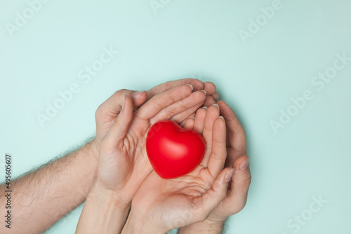 Fototapeta Naklejka Na Ścianę i Meble -  Man and woman hands holding red heart, health care, donate and family insurance concept, world heart day.