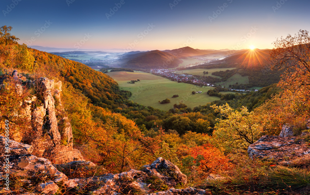 Mountain valley forest in autumn with village in Slovakia