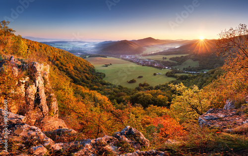 Mountain valley forest in autumn with village in Slovakia