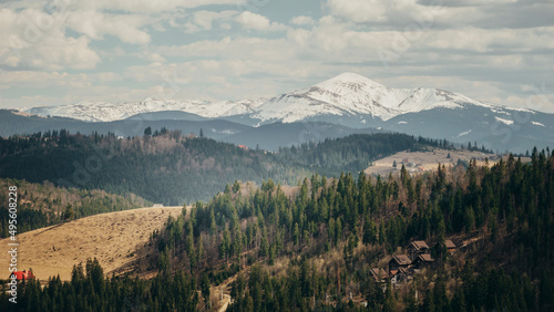 Fototapeta Naklejka Na Ścianę i Meble -  beautiful landscape of mountains and houses, against the backdrop of snow-capped mountains Ukraine Carpathians