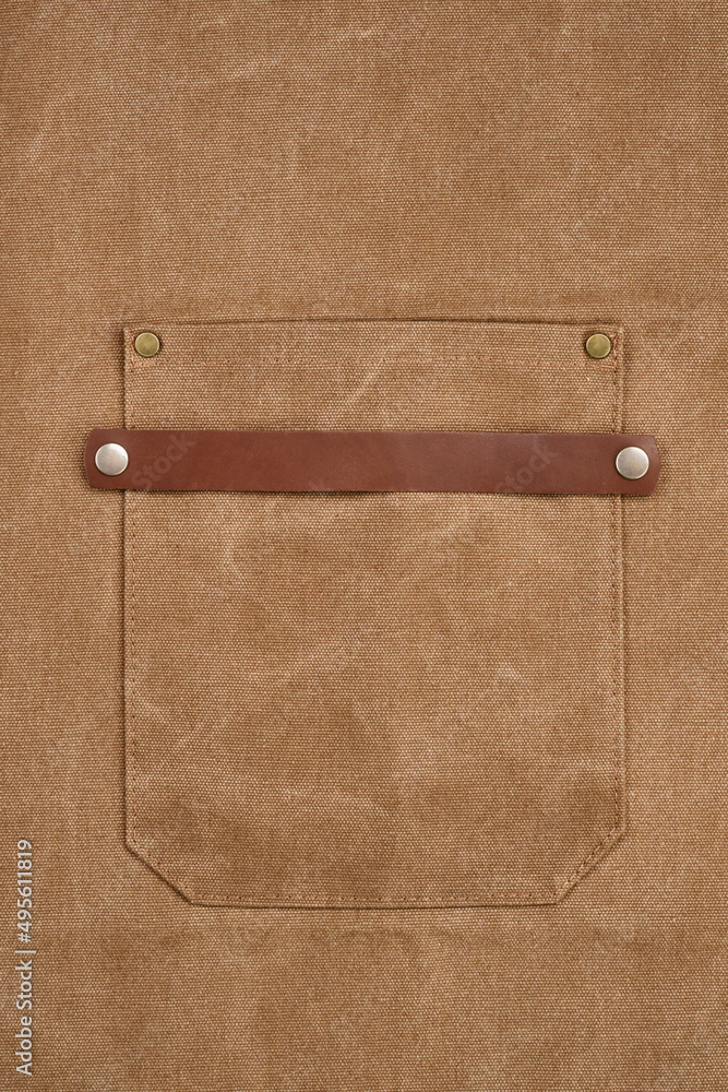 Fototapeta premium Brown apron pocket with rivets. Selective focus