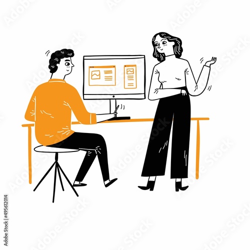 Employees talk near their desks about work they do together.