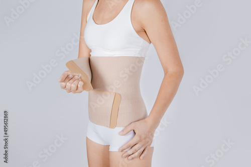 Lumbar brace on the human body isolated on a white background. Trauma of back. Back brace, orthopedic lumbar, support belt for back muscles. Lower back problems health