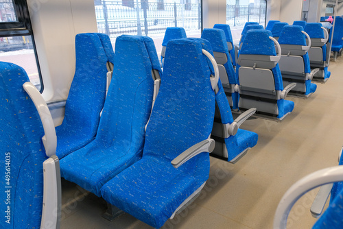 A row of seats in public transport. Blue chairs for a long trip.