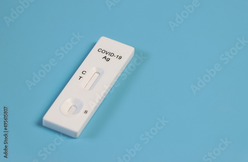 Covid-19 antigen test kit on blue background.