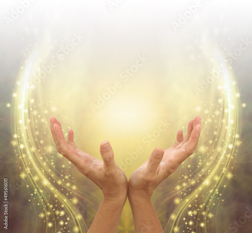фотографія Absorbing Golden Ethereal Energy Healing  -  female cupped hands reaching up int