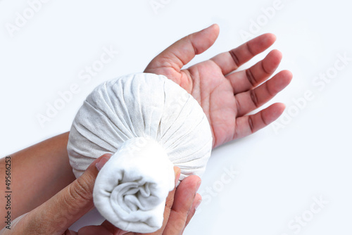 Принти на полотні woman using steamed thai herbal compresses to relieve pain and reduce swelling in wrist