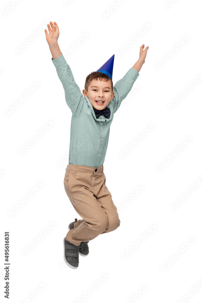 birthday, childhood and people concept - portrait of smiling little boy in party hat jumping over white background birthday, childhood and people concept - portrait of smiling little boy in party hat jumping over white background