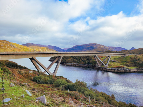 Beautiful view of the Kylesku Bridge against blue cloudy sky on a sunny day in Larig, Scotland, UK photo