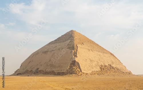 View of Pyramid of Snefru  Bent Pyramid on a blue clouded sky background  at Dahshur  Egypt. The southern pyramid in Dahshur is called cut or diamond-shaped. Cairo  Egypt