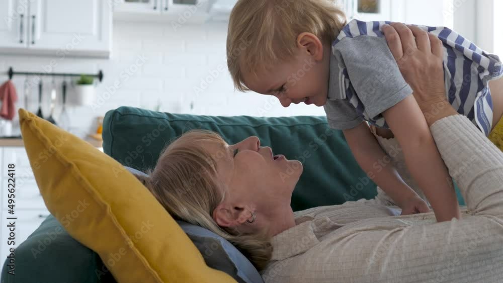 Grandmother And Grandson Laugh Funny Playing And Making Sounds On Couch Grandmother And Grandson Laugh Funny Playing And Making Sounds On Couch