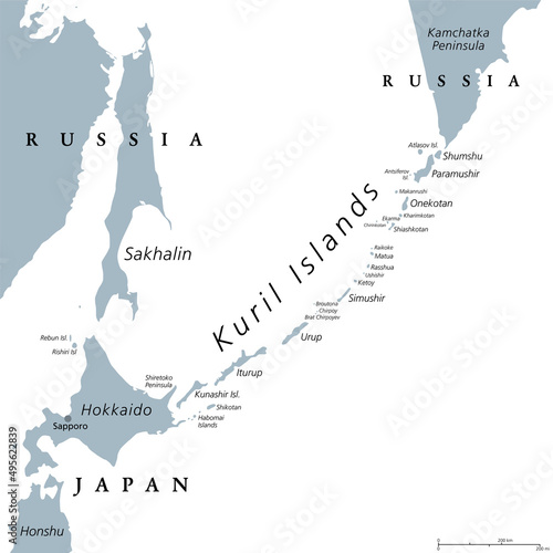 Kuril Islands, gray political map. A volcanic archipelago part of Sakhalin Oblast in Russian Far East. Stretches from Hokkaido in Japan to Kamchatka Peninsula in Russia. Under Russian administration.