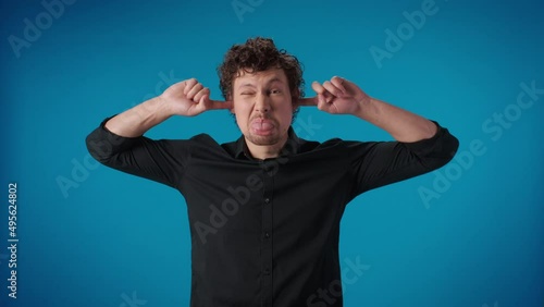 Comical curly man fooling closed ears fingers don't want listening squeamish crazy face expression