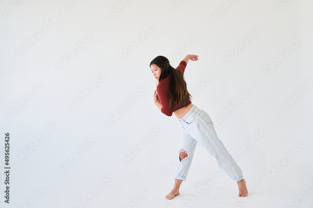 profile if dancing woman leaning forward with arm in air