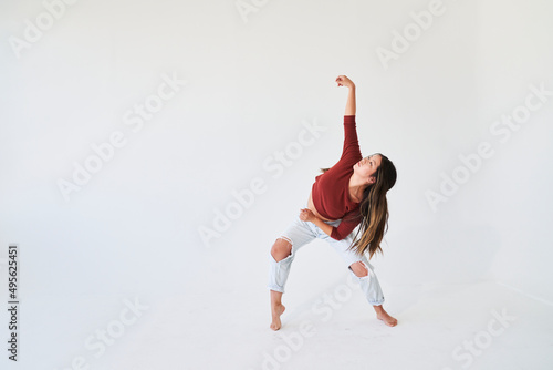 woman dancing looking up and reaching arm in air