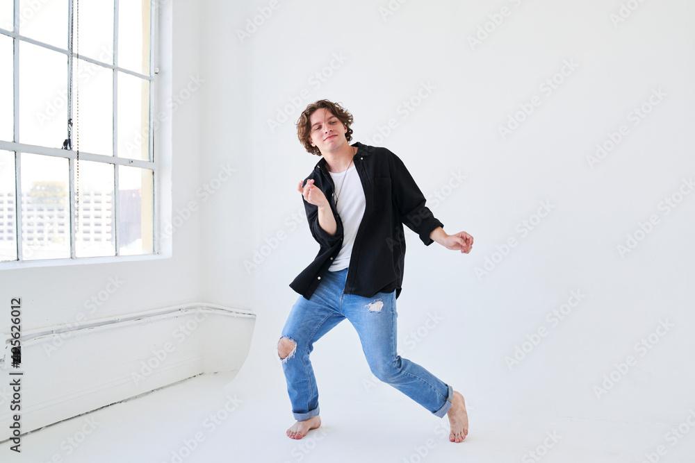 man dancing by window smiling man dancing by window smiling