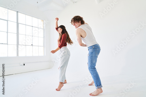 profile of woman and man dancing facing window