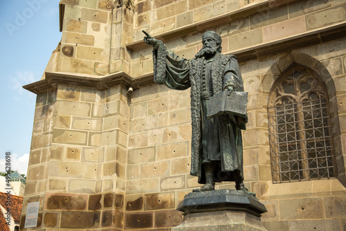 Low-angle shot of the Statue of Honterus outside the church in Brasov, Romania photo