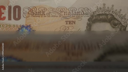 10 English Pound banknotes in cash machine. UK cash counting video. Financial and business concept. photo