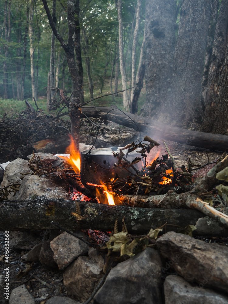 In the cauldron, food is cooked over a fire.
Tourists kindled a bonfire made by hand from stones, dry branches, logs, leaves. The concept of a tourist hike in the forest. In the cauldron, food is cooked over a fire.
Tourists kindled a bonfire made by hand from stones, dry branches, logs, leaves. The concept of a tourist hike in the forest.