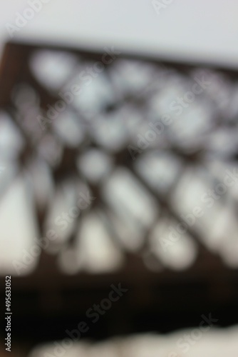 dreamy blurry view of a rustic metal bridge truss © Lina