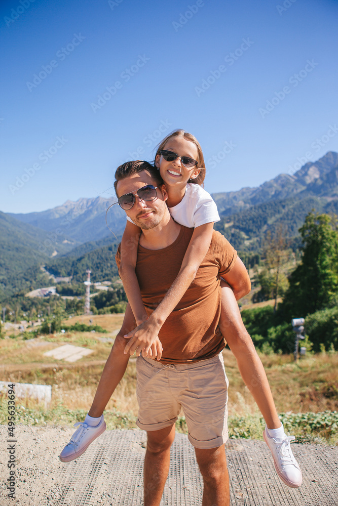 Beautiful happy family in mountains in the background Beautiful happy family in mountains in the background