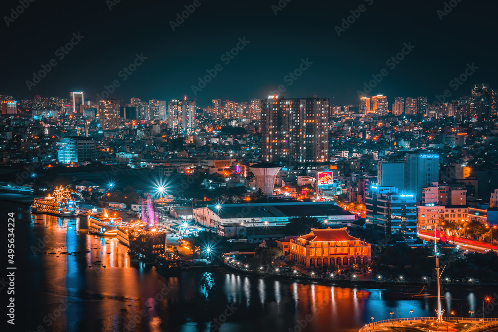 Obraz premium Enjoy the Nha Rong wharf and Bach Dang harbor in Ho Chi Minh City (Saigon). Colorful Saigon river at night.. Travel concept.