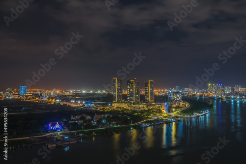 Fototapeta Naklejka Na Ścianę i Meble -  Aerial view of Bitexco Tower, buildings, roads, Thu Thiem 2 bridge and Saigon river in Ho Chi Minh city - Far away is Landmark 81 skyscrapper. This city is a popular tourist destination of Vietnam