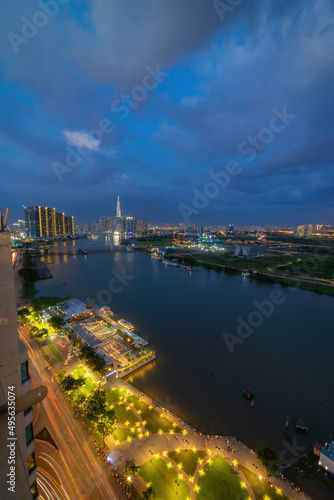 Aerial view of Bitexco Tower, buildings, roads, Thu Thiem 2 bridge and Saigon river in Ho Chi Minh city - Far away is Landmark 81 skyscrapper. This city is a popular tourist destination of Vietnam © CravenA