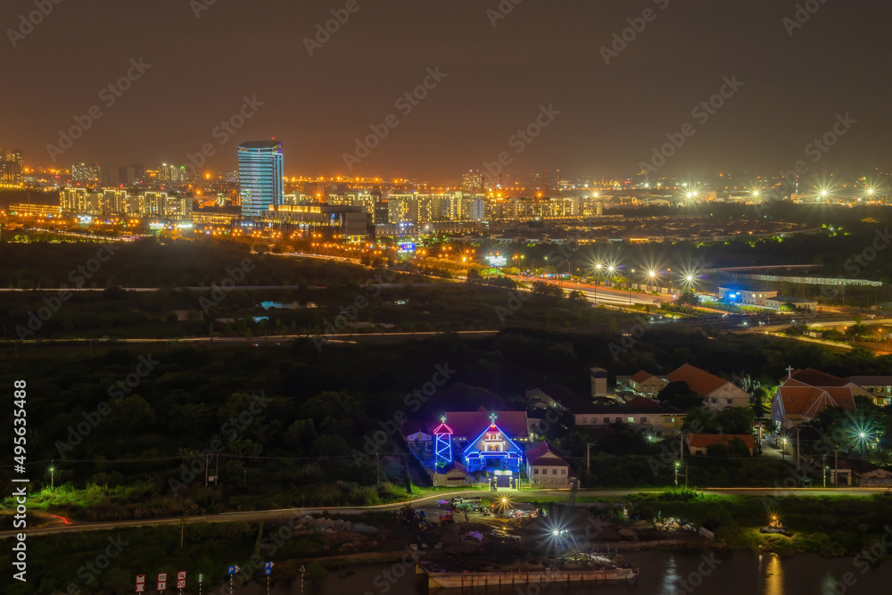 Aerial view of Bitexco Tower, buildings, roads, Thu Thiem 2 bridge and Saigon river in Ho Chi Minh city - Far away is Landmark 81 skyscrapper. This city is a popular tourist destination of Vietnam